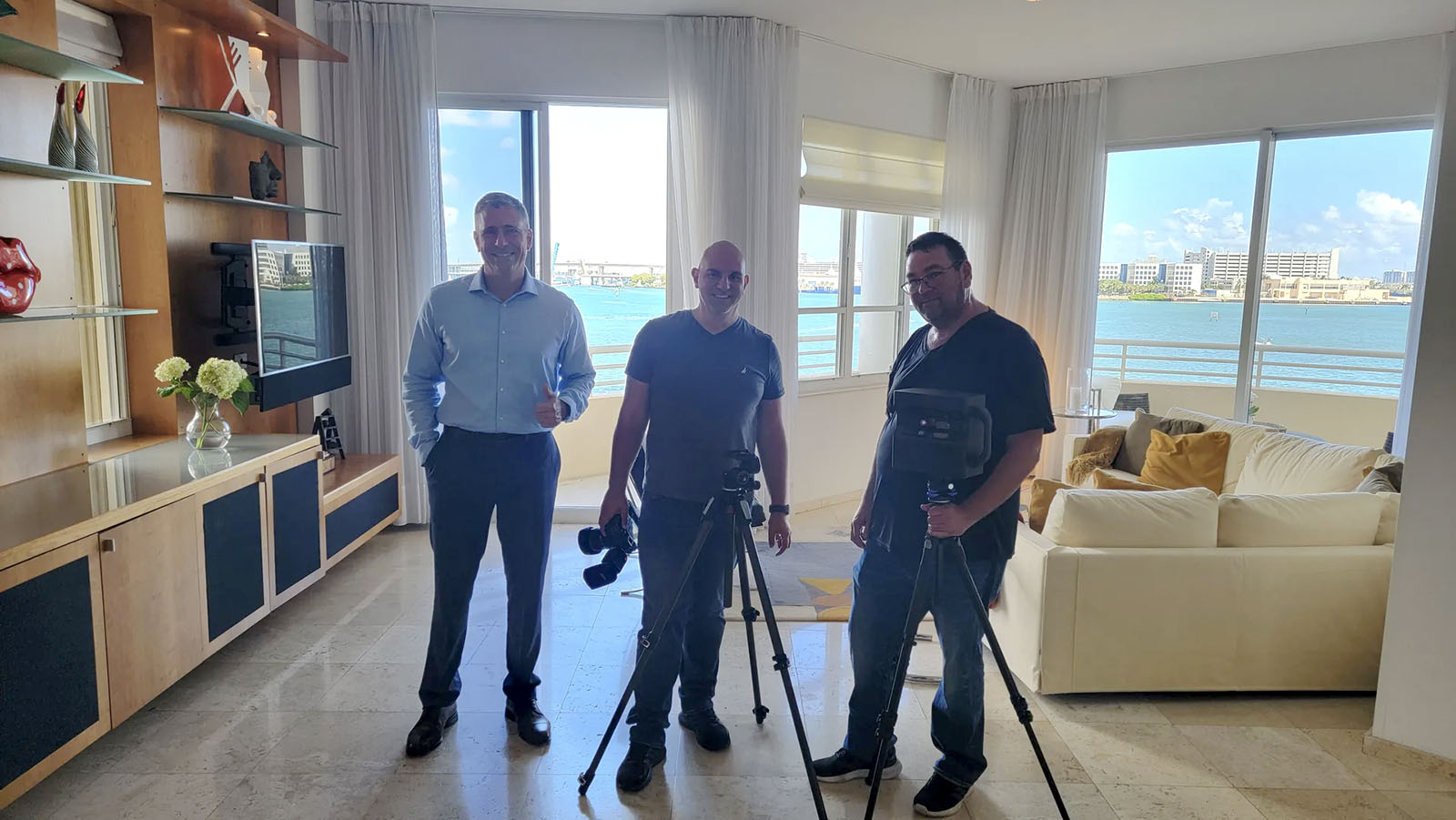 Carlos Uzcategui with the property media team preparing photography and video at a waterfront home